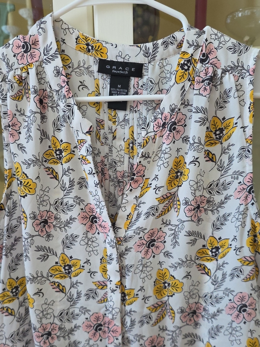 Grace white sleeveless blouse with pink and yellow floral print
